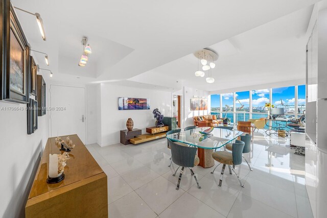 dining space with expansive windows and light tile patterned flooring