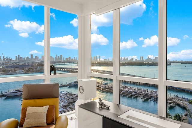 sunroom featuring a water view