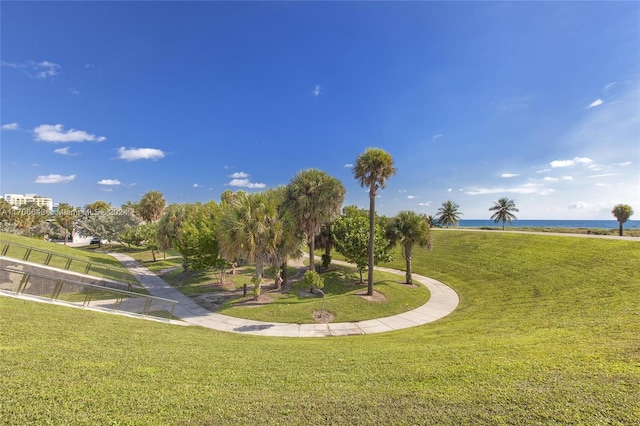 view of community featuring a lawn and a water view