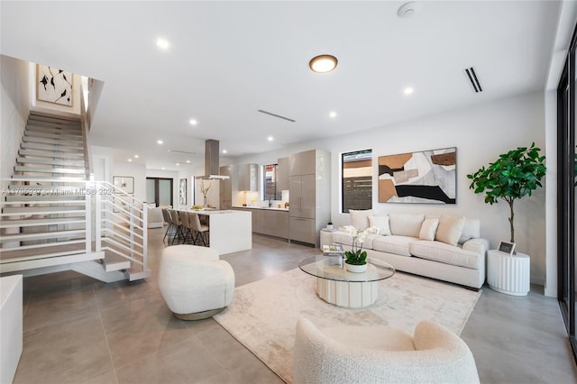 living room with concrete flooring and sink