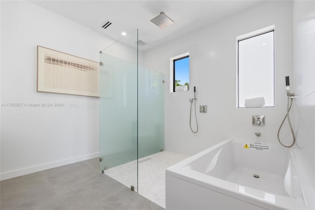 bathroom featuring shower with separate bathtub