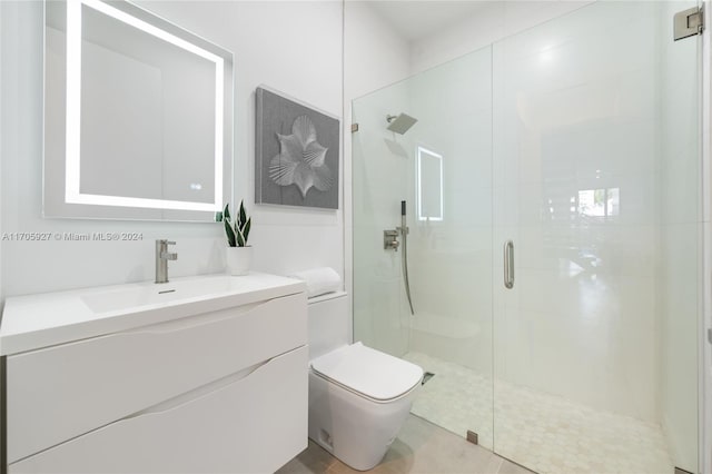 bathroom with tile patterned floors, vanity, an enclosed shower, and toilet