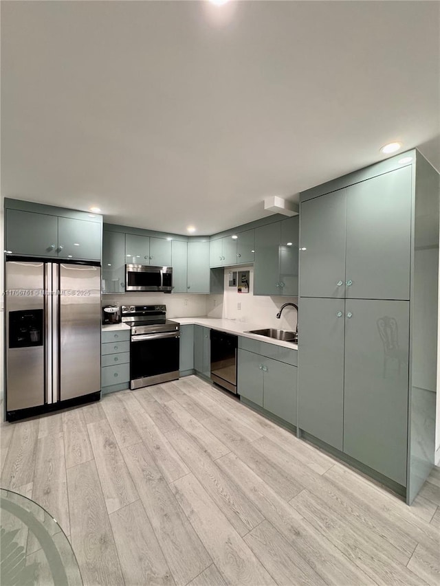 kitchen featuring sink, light hardwood / wood-style flooring, and stainless steel appliances