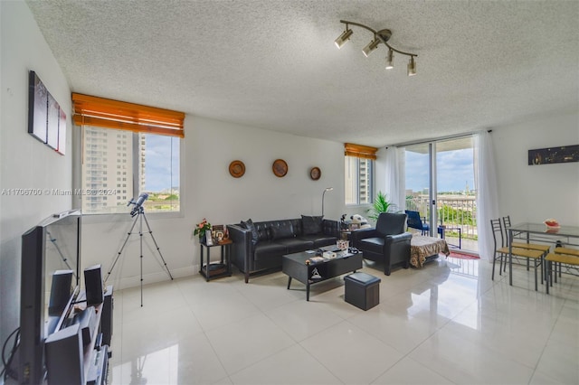 living room featuring light tile patterned floors and a textured ceiling