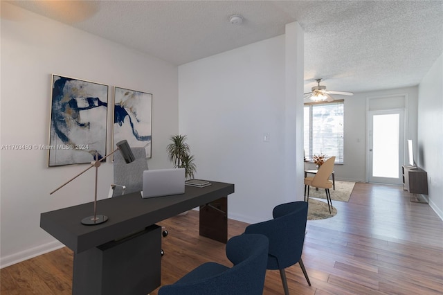 office with hardwood / wood-style floors, a textured ceiling, and ceiling fan