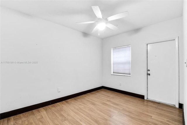 spare room with light wood-type flooring and ceiling fan