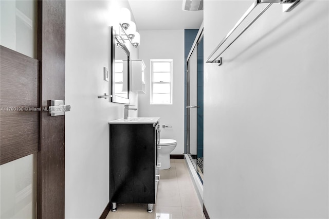 bathroom with tile patterned flooring, vanity, toilet, and an enclosed shower