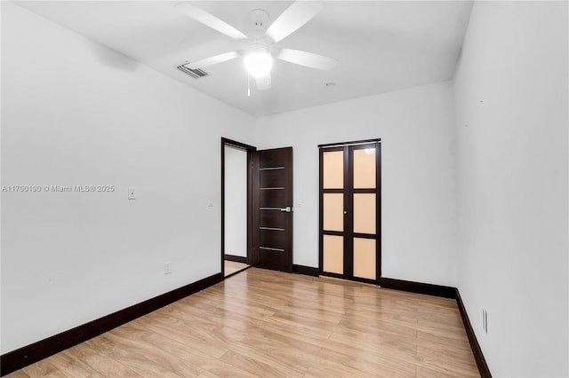 empty room featuring ceiling fan and light wood-type flooring