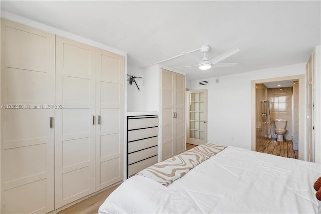 bedroom with ceiling fan, light hardwood / wood-style floors, and ensuite bath