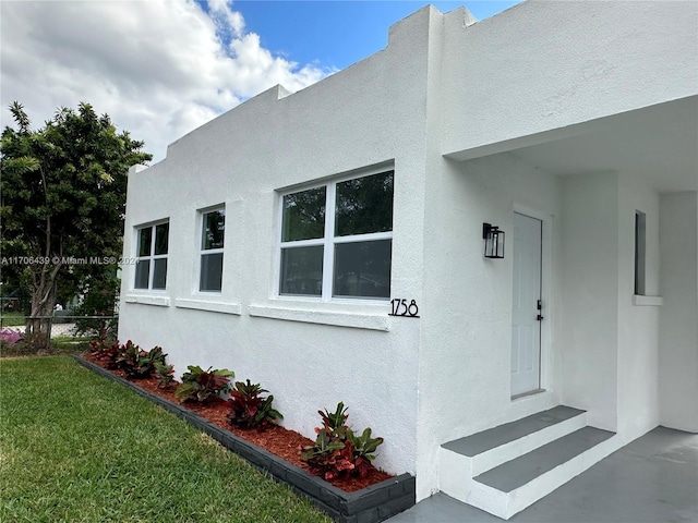 view of side of home with a yard