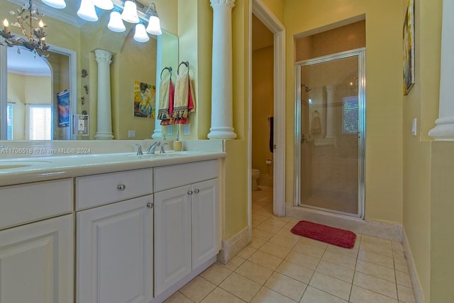 bathroom featuring tile patterned floors, toilet, an enclosed shower, and ornate columns