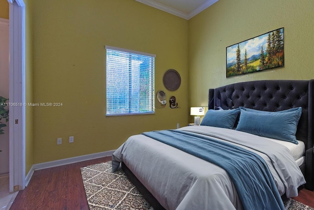 bedroom with ornamental molding and dark wood-type flooring