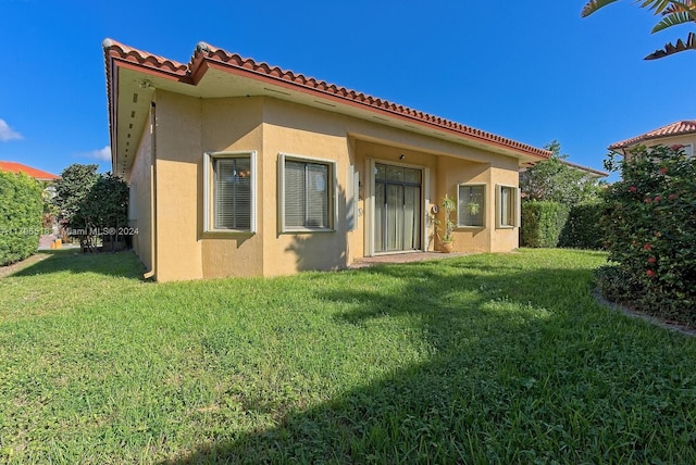 rear view of house with a yard