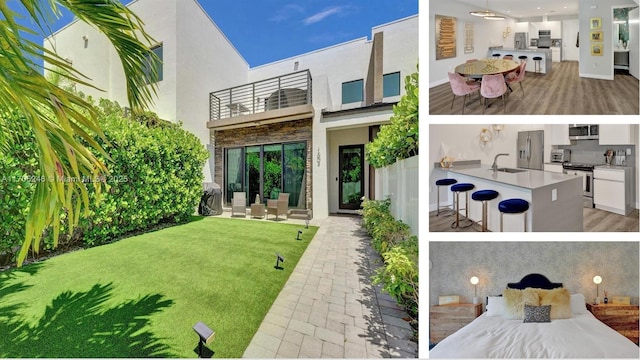 back of house with a patio, a balcony, a lawn, area for grilling, and a wet bar