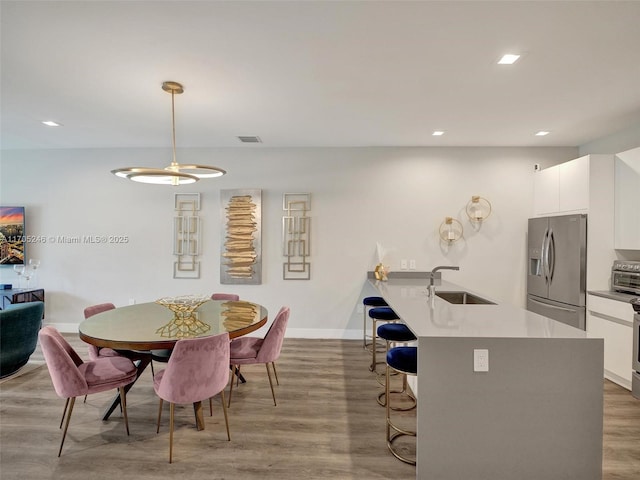 dining room featuring sink and hardwood / wood-style floors