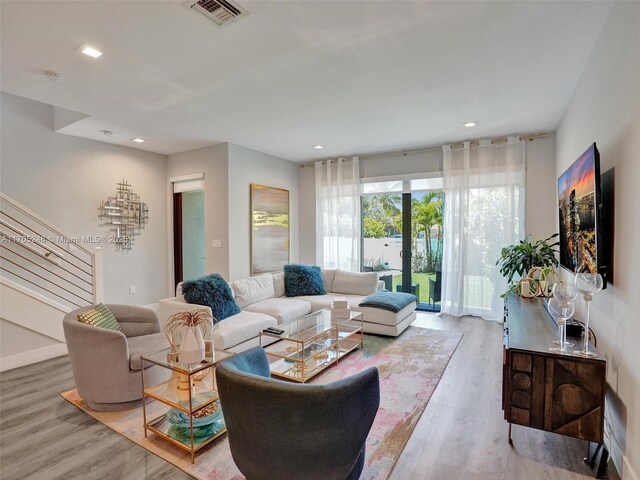 bedroom featuring hardwood / wood-style floors, ceiling fan, a spacious closet, and a closet