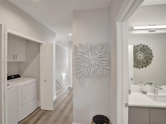 bathroom with hardwood / wood-style floors, vanity, and a shower with shower door