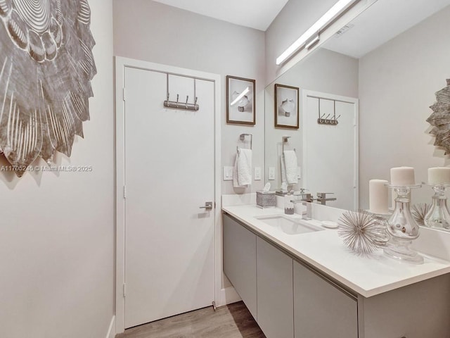 bathroom with vanity and hardwood / wood-style flooring