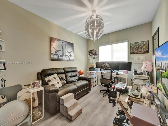 office area featuring a notable chandelier and light hardwood / wood-style flooring