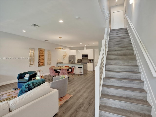 stairs with wood-type flooring