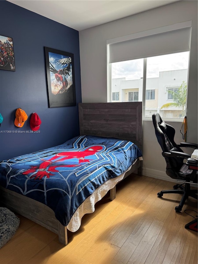 bedroom with hardwood / wood-style floors