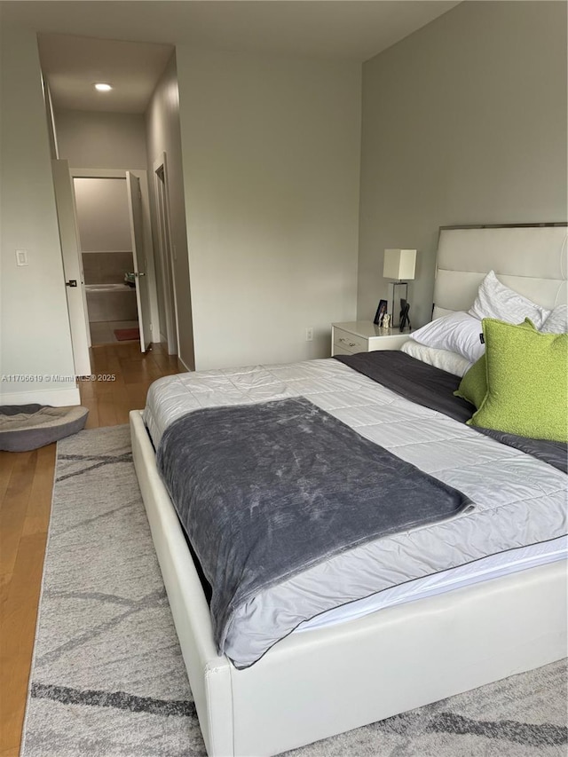 bedroom with wood-type flooring