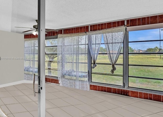 interior space with ceiling fan and a wealth of natural light