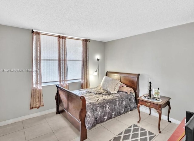 tiled bedroom with a textured ceiling