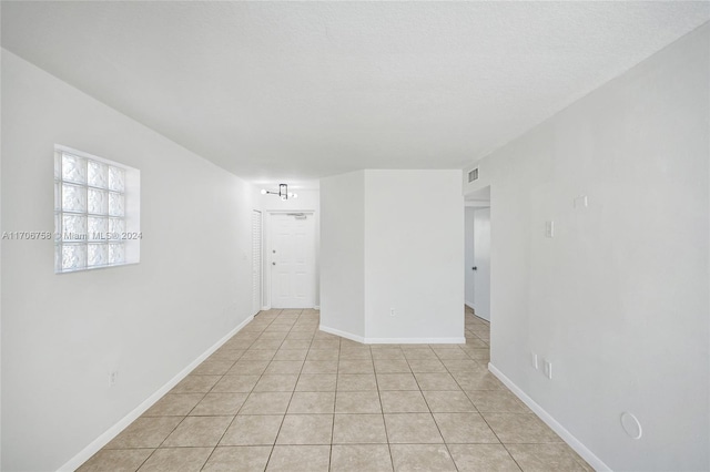 spare room with light tile patterned floors