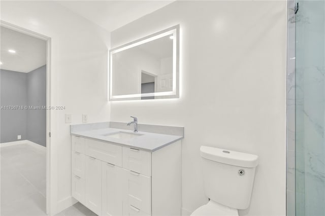 bathroom featuring a shower, tile patterned flooring, vanity, and toilet