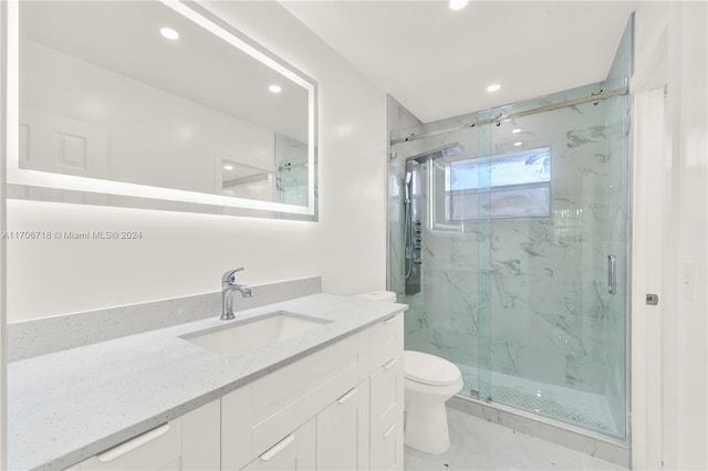 bathroom featuring an enclosed shower, vanity, and toilet