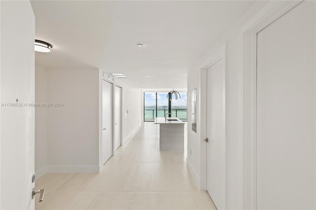 hallway featuring light tile patterned floors