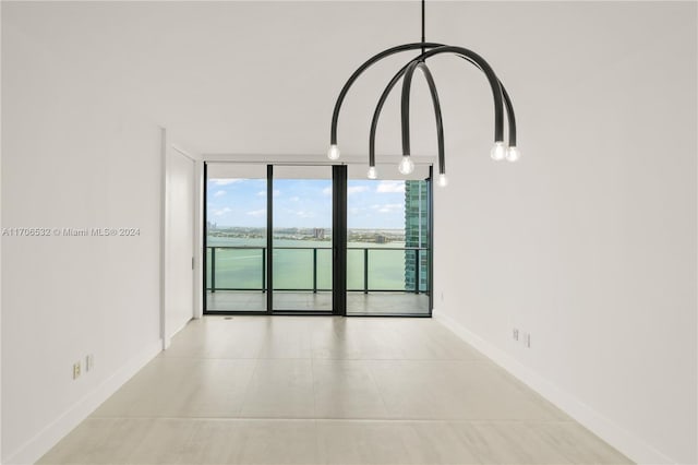 interior space with expansive windows and a water view