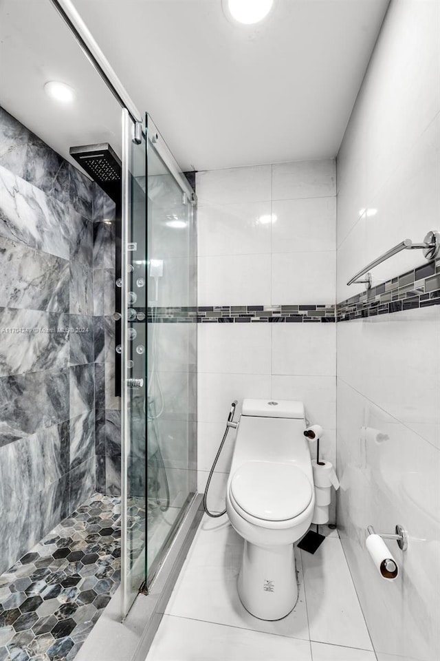 bathroom featuring an enclosed shower, tile walls, and toilet