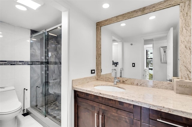 bathroom with vanity, toilet, and walk in shower