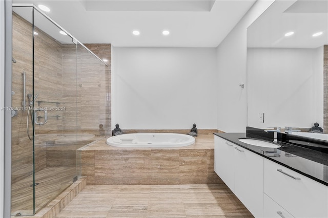 bathroom featuring shower with separate bathtub and vanity