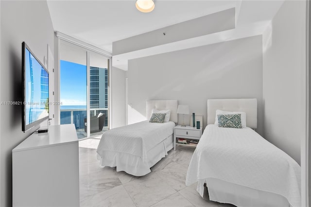 bedroom with floor to ceiling windows and access to exterior