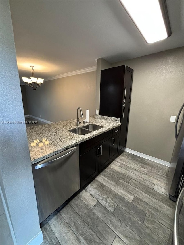 kitchen with dishwasher, kitchen peninsula, sink, an inviting chandelier, and ornamental molding