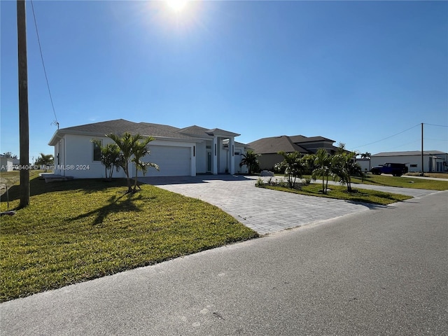 view of front of property featuring a front yard and a garage