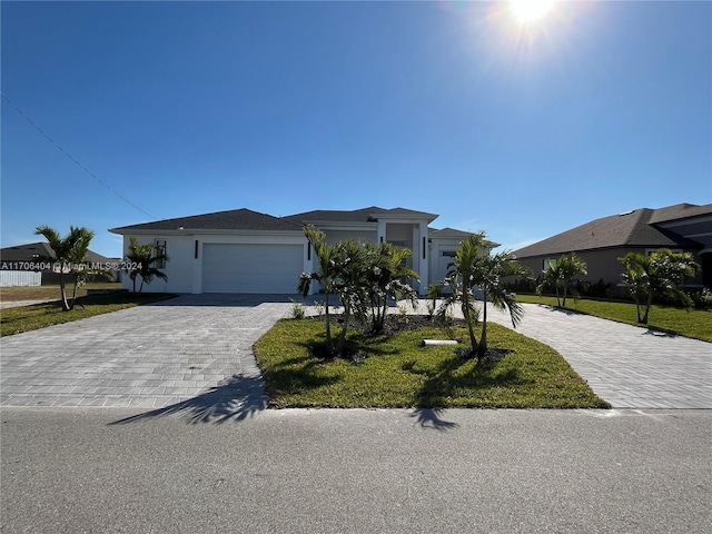 ranch-style house with a front lawn and a garage