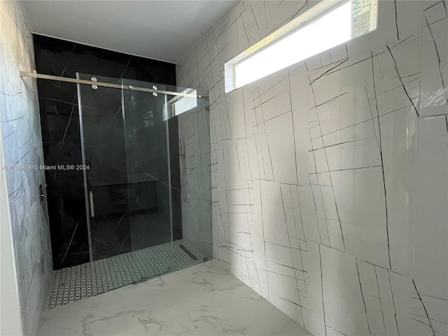 bathroom featuring a shower with shower door