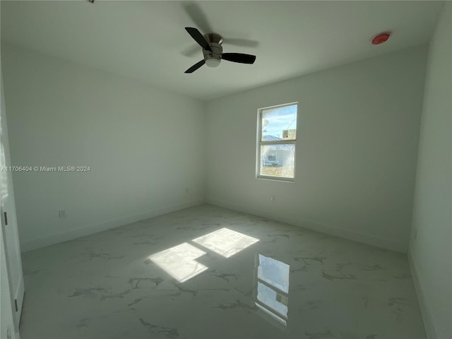 spare room with ceiling fan