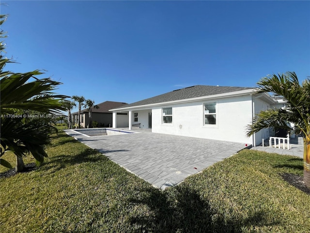 back of house featuring a yard and a patio area