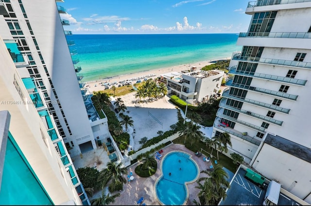 birds eye view of property with a beach view and a water view