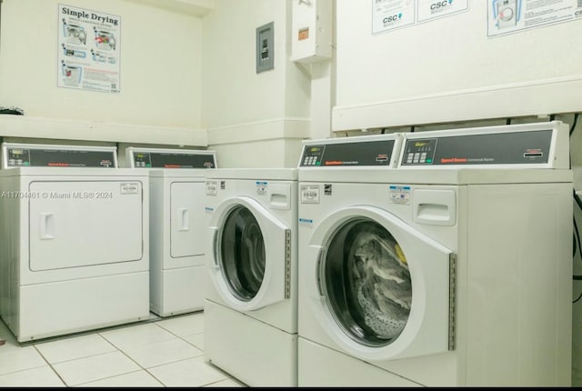 laundry area with light tile patterned floors and separate washer and dryer