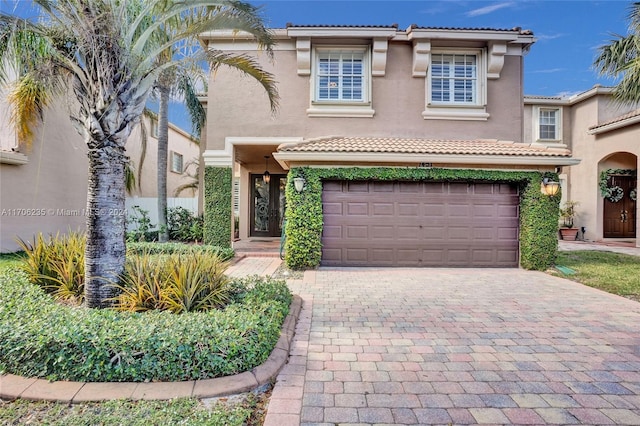 mediterranean / spanish-style home featuring a garage