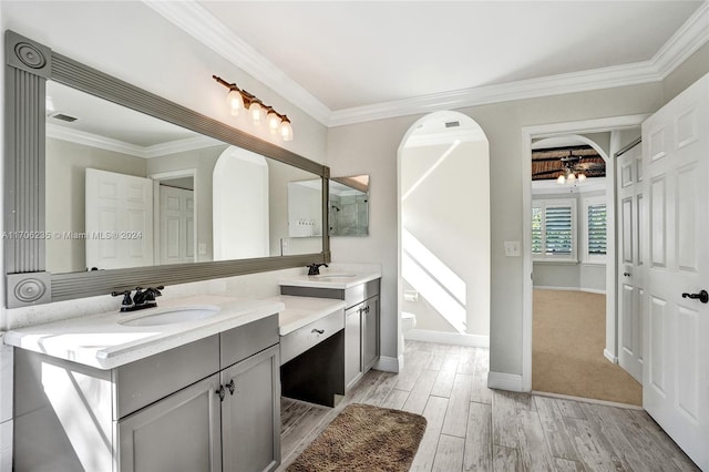 bathroom featuring crown molding, vanity, and hardwood / wood-style flooring