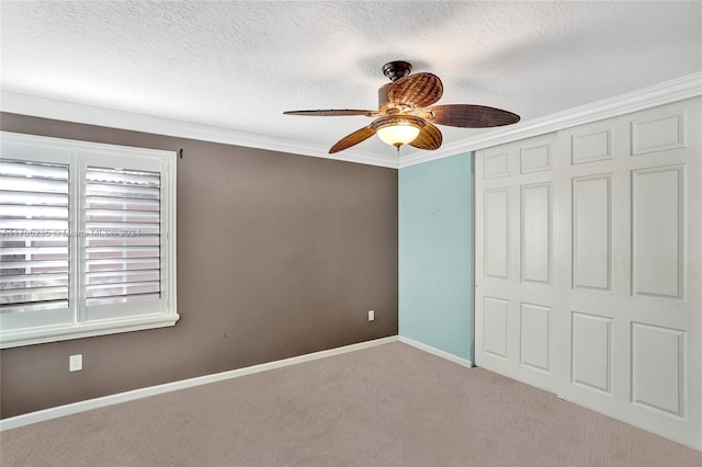 unfurnished bedroom featuring ceiling fan, light colored carpet, crown molding, and a closet