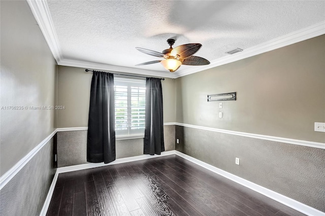 spare room with a textured ceiling, dark hardwood / wood-style flooring, ceiling fan, and ornamental molding