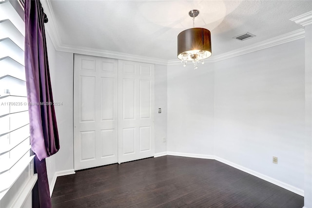 unfurnished bedroom with dark hardwood / wood-style floors and ornamental molding